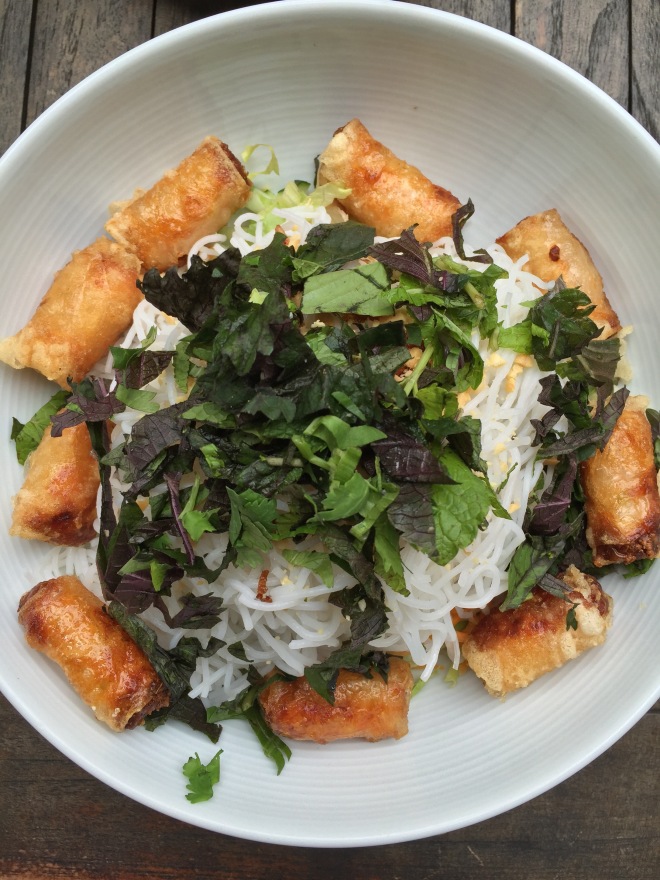 Rice noodle bowl with spring rolls
